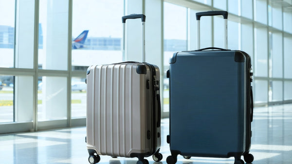 Travel-ready expandable hardcase luggage in silver and navy, designed for secure and flexible packing at the airport