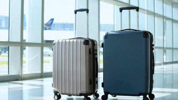 Travel-ready expandable hardcase luggage in silver and navy, designed for secure and flexible packing at the airport